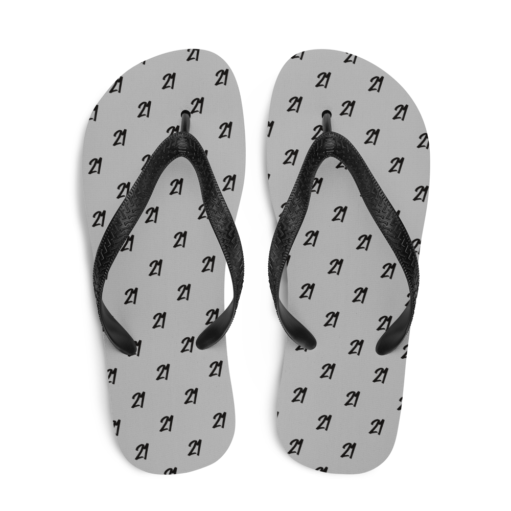 Top view of a pair of silver and black bitcoin flip flops.