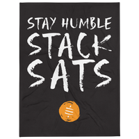 Stay Humble Stack Sats bitcoin throw blanket, front view: STAY HUMBLE STACK SATS in white brush lettering on black above a small orange coin, printed across the blanket.