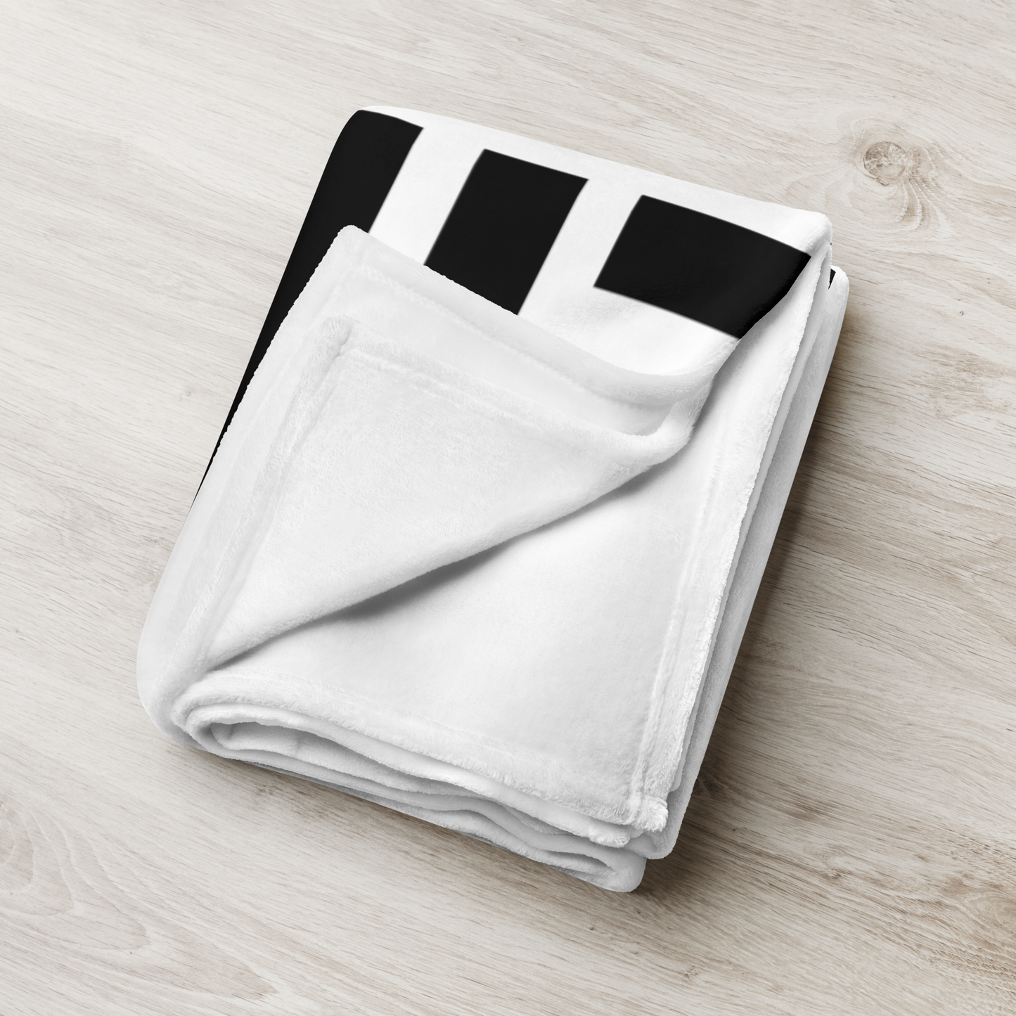 Detailed view of the folded white bitcoin blanket.