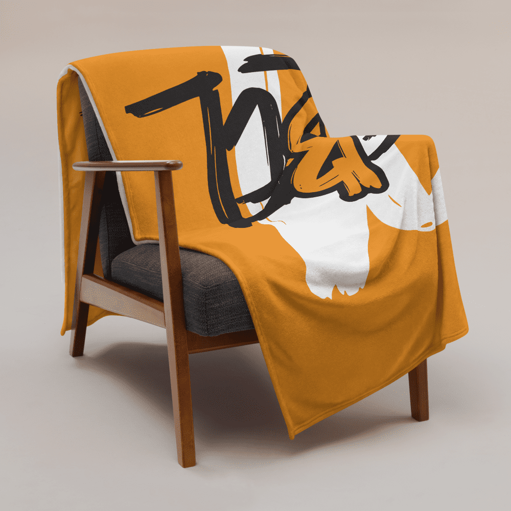 Orange bitcoin blanket hanging over an armchair.