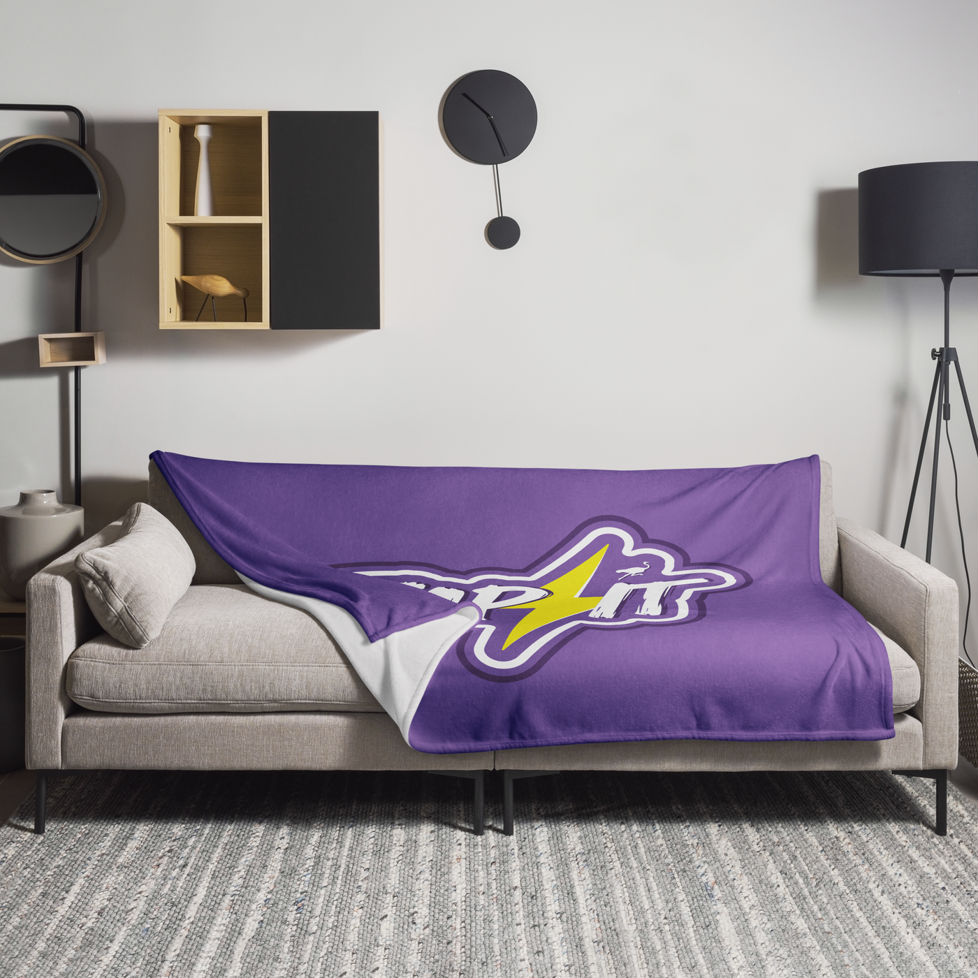 Zap It Nostr throw blanket spread across a light grey sofa in a living room, showing the design in a home setting.