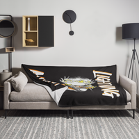Zeus Supporter Bitcoin throw blanket spread across a light grey sofa in a living room, showing the design in a home setting.